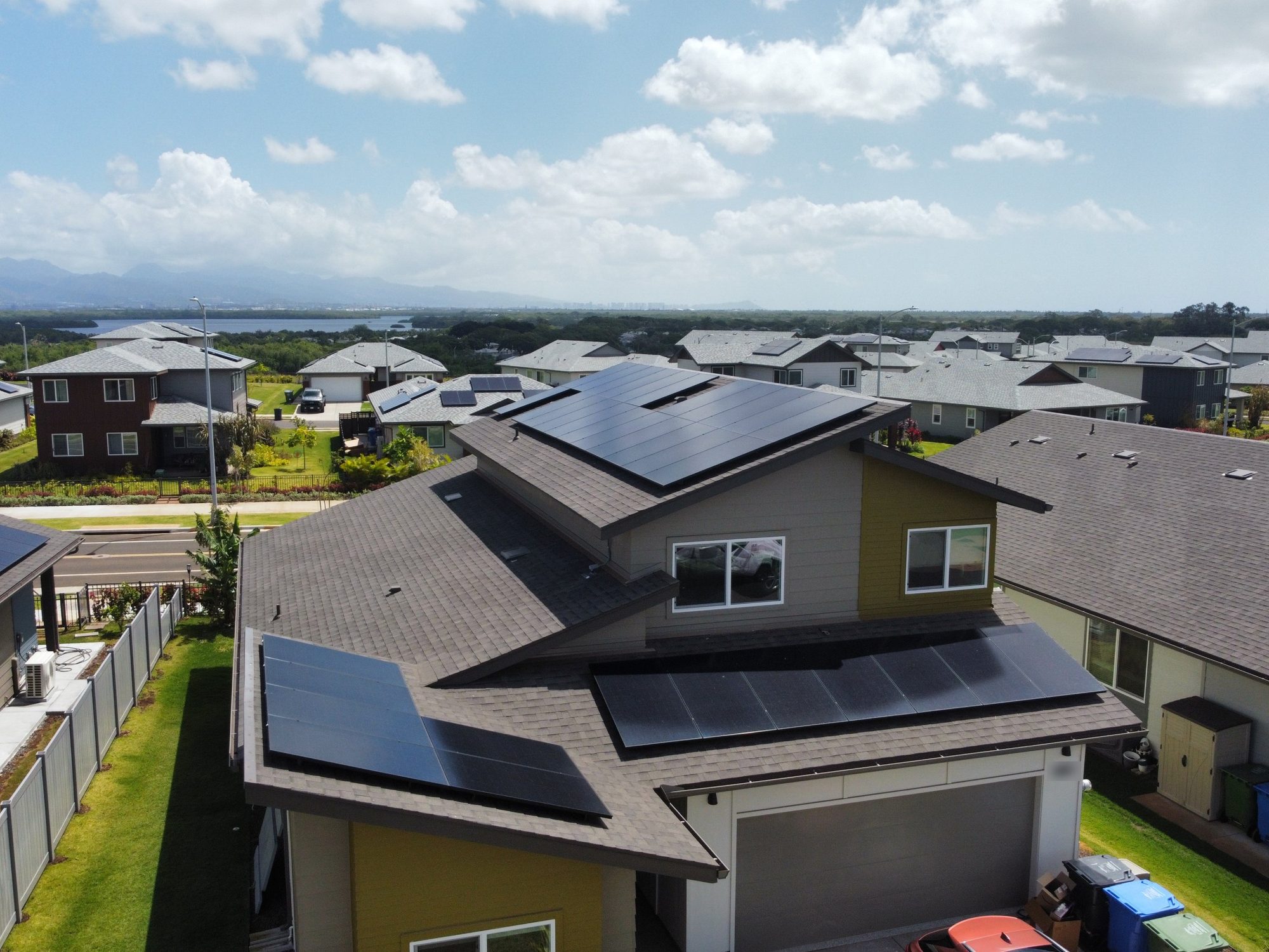 Two-story Oahu home with solar panels on three roof sections