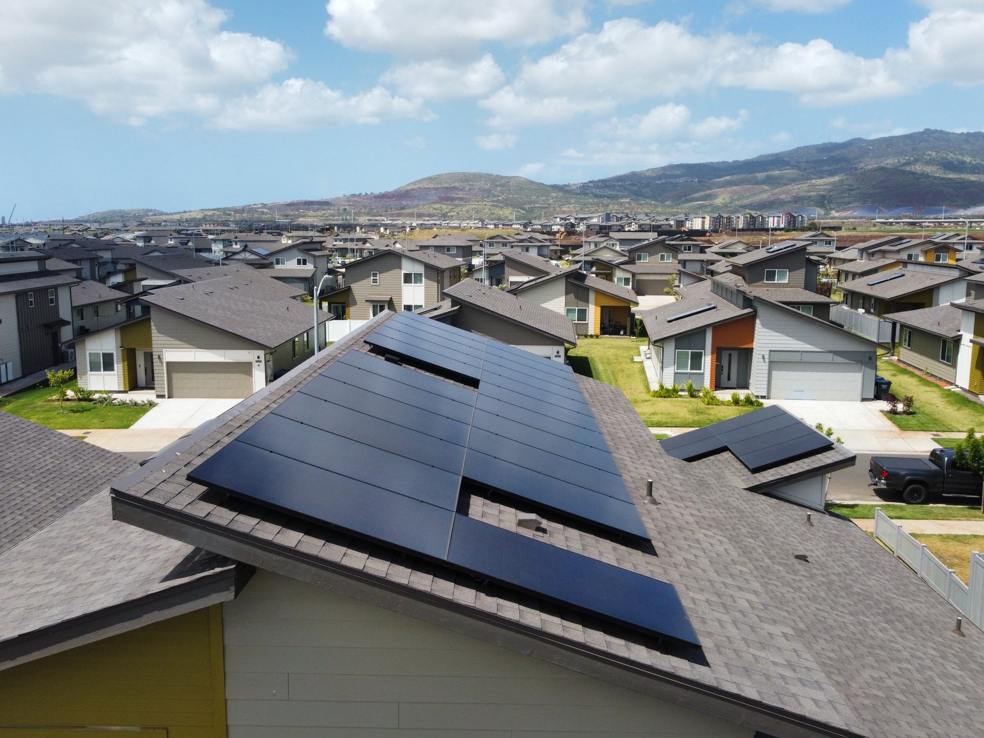 Close-up of sleek all-black solar panels on an Oahu roof